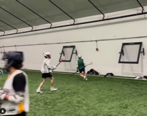 lacrosse players practicing wall ball